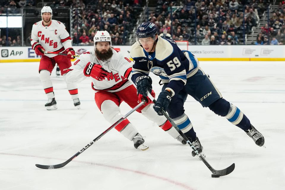 Feb 29, 2024; Columbus, Ohio, USA; Columbus Blue Jackets right wing Yegor Chinakhov (59) skates past Carolina Hurricanes defenseman Brent Burns (8) during the first period of the NHL hockey game at Nationwide Arena.