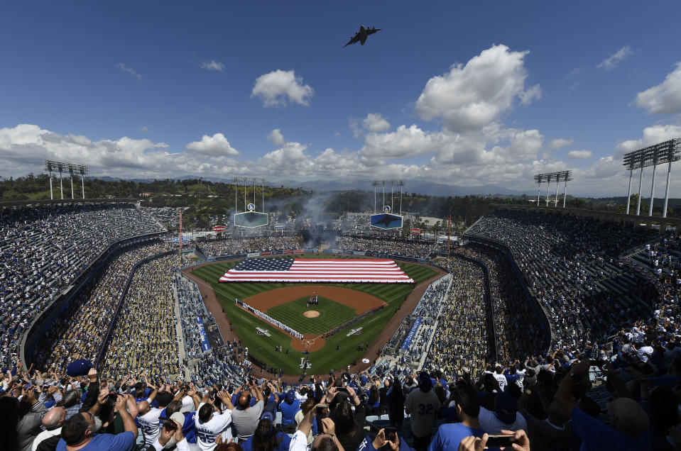 LOS ANGELES, CA - MARCH 28: Fans cheer as a Boeing C-17 Globemaster III military transport aircraft conducts a flyover from the 452nd Air Mobility Wing from March Air Reserve Base during the National Anthem onOpening Day between the Los Angeles Dodgers and Arizona Diamondbacks at Dodger Stadium on March 28, 2019 in Los Angeles, California. (Photo by Kevork Djansezian/Getty Images)