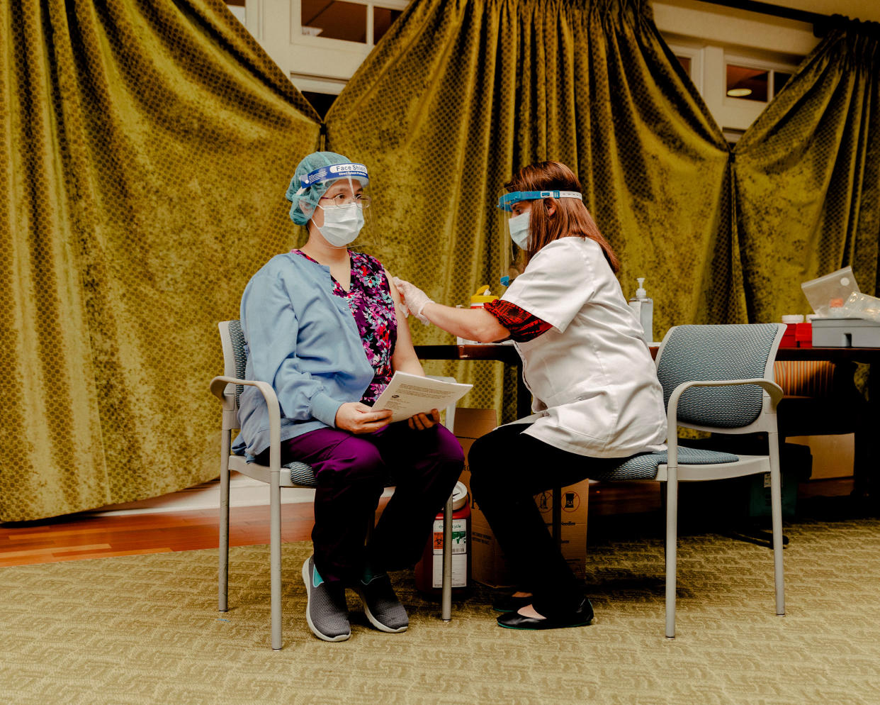 An employee of Westminster Place is vaccinated on Jan. 6, 2021.