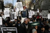 Muslim demonstrators hold placards during a protest against the publication of cartoons depicting the Prophet Mohammad in French satirical weekly Charlie Hebdo, near Downing Street in central London February 8, 2015. REUTERS/Stefan Wermuth