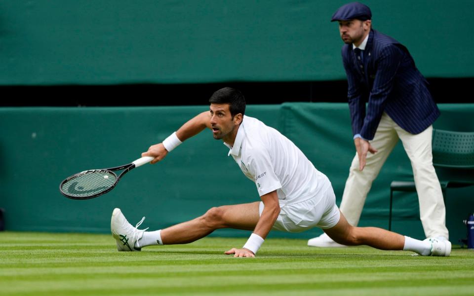 Serbia's Novak Djokovic slips on the grass during the men's singles second round match against South Africa's Kevin Anderson  - AP Photo/Alastair Grant