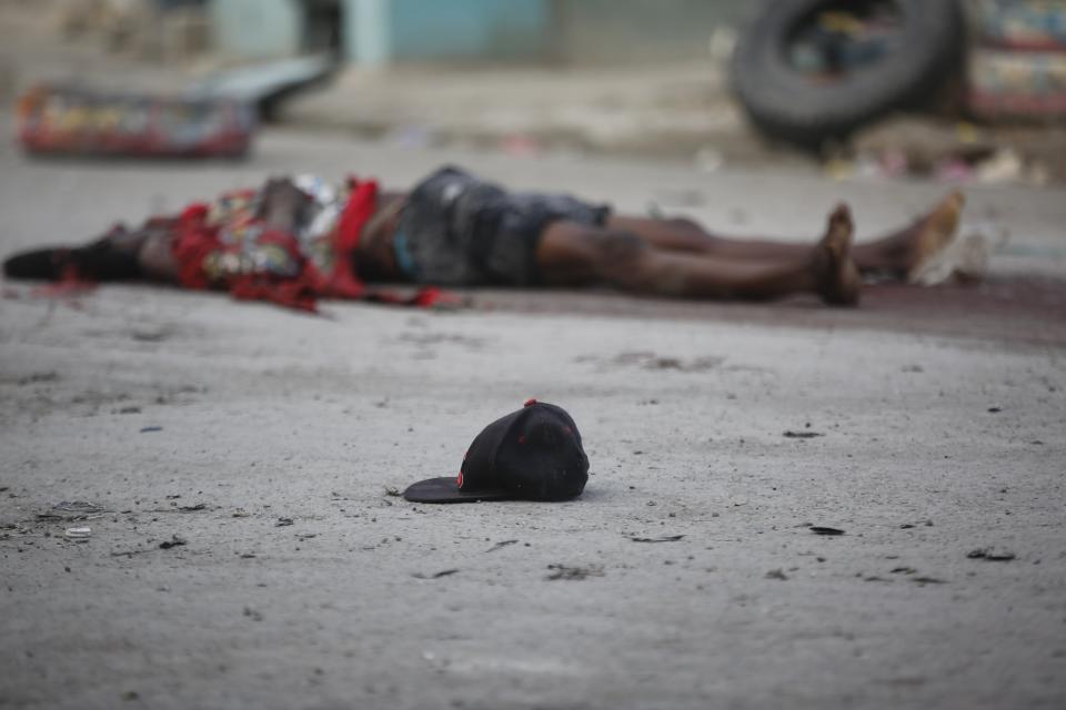 A man's body lies on a street during a police anti gang operation at the Portail neighborhood in Port-au-Prince, Haiti, Thursday, Feb. 29, 2024. Gunmen shot at the international airport and other targets in a wave of violence that forced businesses, government agencies and schools to close early. (AP Photo/Odelyn Joseph)