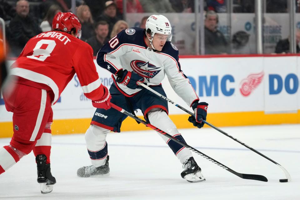 Columbus Blue Jackets left wing Dmitri Voronkov (10) controls the puck as Detroit Red Wings defenseman Ben Chiarot (8) defends in the first period of an NHL hockey game Saturday, Nov. 11, 2023, in Detroit. (AP Photo/Paul Sancya)