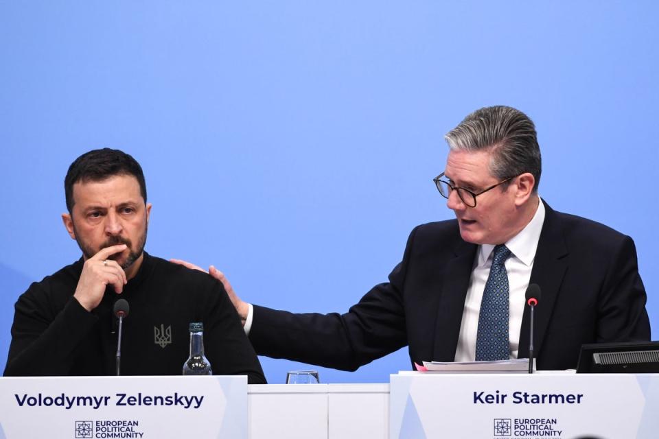 Sir Keir Starmer touched Mr Zelensky’s shoulder as he highlighted the Ukrainian leader’s comments calling for more air defences to protect children as they return to school (EPA)