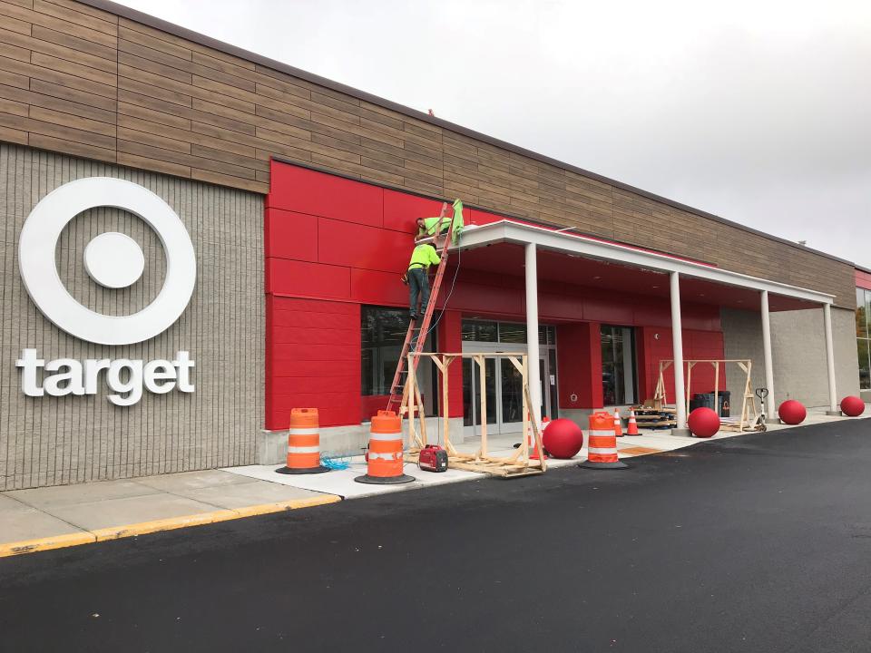 Workers put the finishing touches on the main entrance to Target in South Burlington on Oct. 3, 2018.