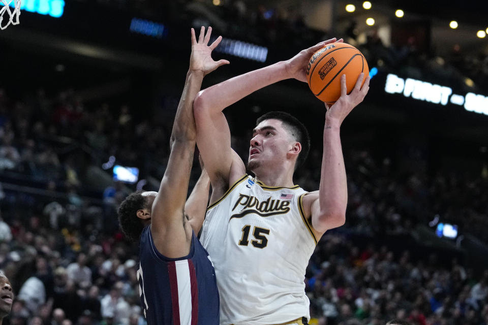 Purdue center Zach Edey (15) shoots over Fairleigh Dickinson forward Cameron Tweedy (21) in the second half of a first-round college basketball game in the men's NCAA Tournament in Columbus, Ohio, Friday, March 17, 2023. (AP Photo/Michael Conroy)