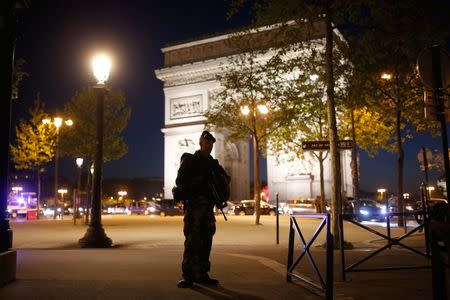 An armed soldier secures a side road near the Champs Elysees Avenue after a shooting incident in Paris, France, April 20, 2017. REUTERS/Benoit Tessier