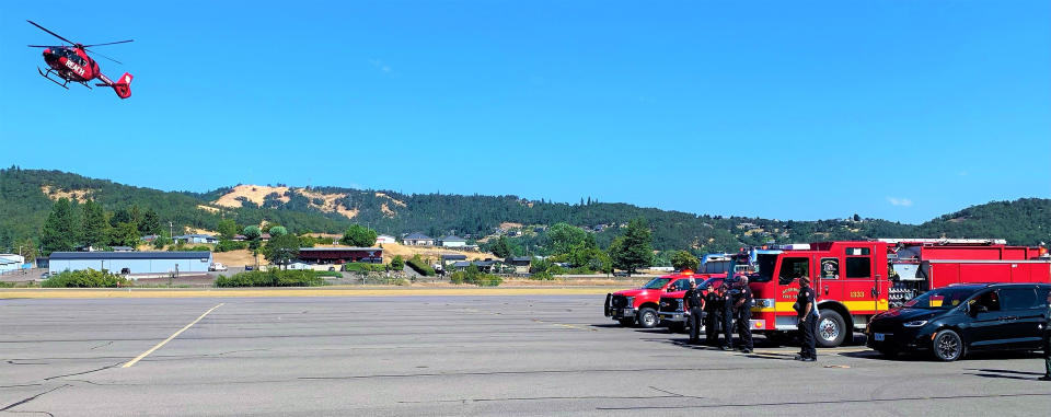 A REACH Air Medical Services helicopter flies the body of wildland firefighter Collin Hagan, 27, of Toivola, Mich. Hagan was critically injured when he was struck by a tree while he was fighting the Big Swamp Fire near Oakridge, Ore. (Douglas County Sheriff's Office via Facebook)