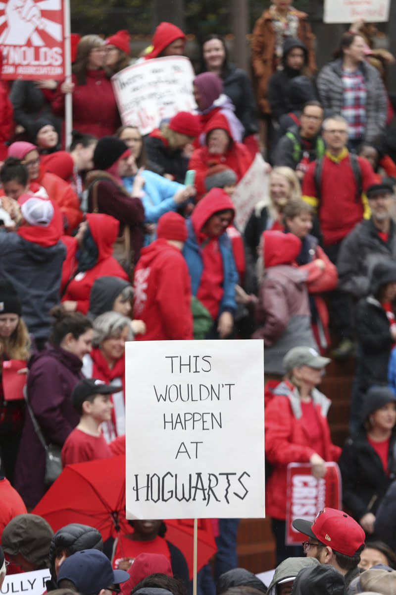 In this April 10, 2019, photo, educators from across the metro hold a rally during a Take it to the MAX event in Portland, Ore., to press the Oregon Legislature for more school funding. Tens of thousands of teachers are expected to walk out across Oregon this week, adding to the string of nationwide protests over class sizes and education funding. (Mark Graves/The Oregonian via AP)