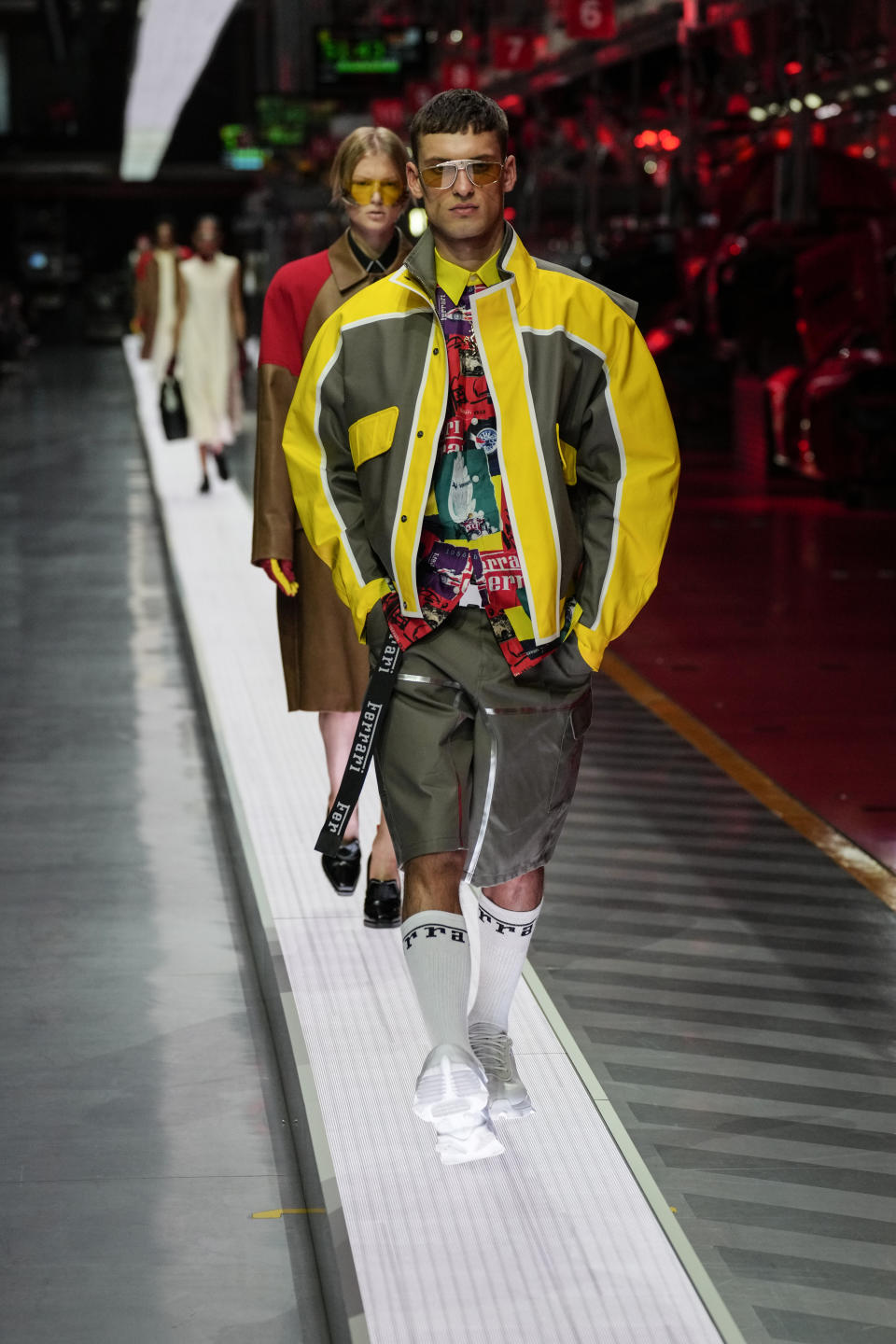 A model wears a creation as part of the Ferrari women's and men's Spring Summer 2022 collection, in Maranello, Italy, Sunday, June 13, 2021. (AP Photo/Antonio Calanni)