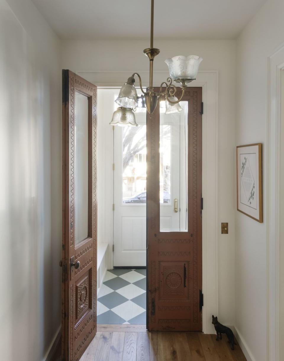 a hallway with a door and a mirror