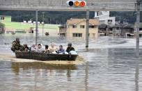 <p>Elderly people are rescued on boat as the city is flooded following heavy rain in Kurashiki city, Okayama prefecture, southwestern Japan, July 8, 2018. Heavy rainfall hammered southern Japan for the third day, prompting new disaster warnings on Kyushu and Shikoku islands on Sunday. (Photo: Kyodo News via AP) </p>