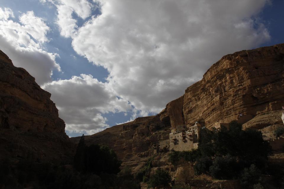 FILE - In this Jan. 16, 2012 file photo St. George Monastery is seen in Judean desert. St. George is a 5th century Byzantine monastery built at the site of the cave where according to Christian faith Elijah the Prophet hid from Jezebel. Located between Jerusalem and Jericho, the Judean Desert provided an inspiration to thousands of hermits who lived here in the early Middle Ages. With its breathtaking, rugged beauty, it was the perfect setting for those searching spiritual fullness in the emptiness of the desert. Today only a handful of monks live here, but the Judean Desert and its stunning monasteries continue to attract thousands of visitors from all over the world. (AP Photo/Dusan Vranic, Files)