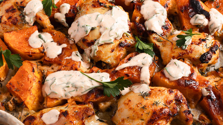 Close up on baked chicken and squash with yogurt