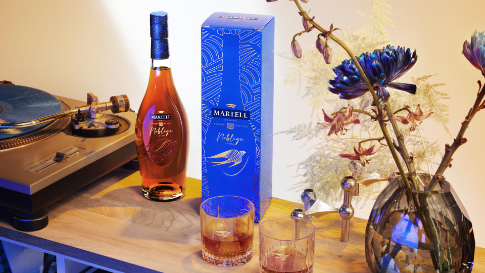 The new Martell Noblige bottle displayed alongside the new vibrant electric blue casing box.