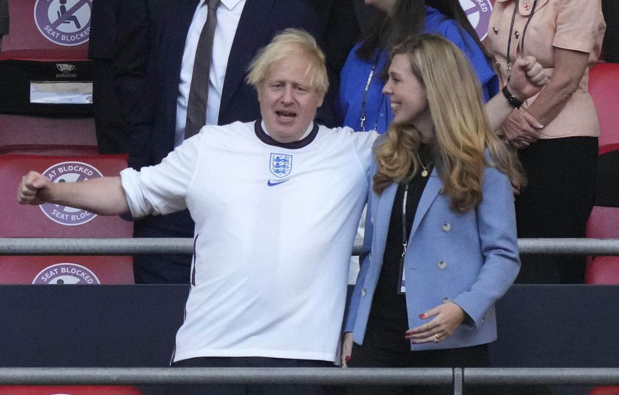 UK Prime Minister Boris Johnson (L) and his spouse Carrie arrive before the start of the UEFA EURO 2020 semi-final football match between England and Denmark at Wembley Stadium in London on July 7, 2021. (Photo by Frank Augstein / POOL / AFP) (Photo by FRANK AUGSTEIN/POOL/AFP via Getty Images)