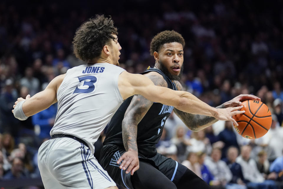 Villanova guard Justin Moorem, right, controls the ball as Xavier guard Colby Jones (3) defends during the second half of an NCAA college basketball game, Tuesday, Feb. 21, 2023, in Cincinnati. (AP Photo/Joshua A. Bickel)