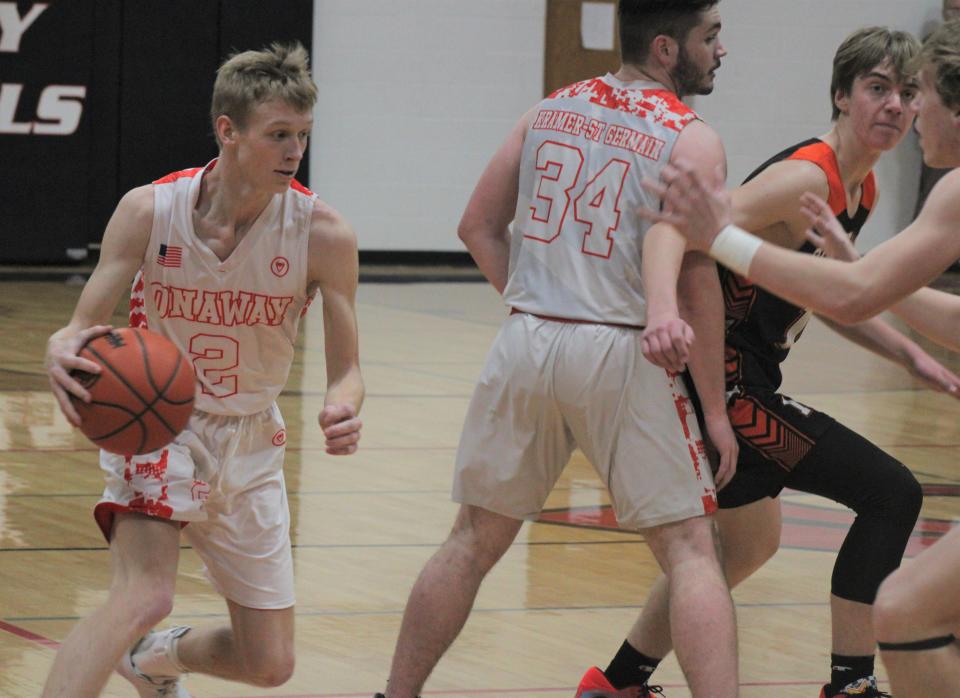 Onaway junior guard Jadin Mix (2) goes around a screen from junior teammate Justin Kramer-St. Germain (34) during the first half against Cheboygan on Friday.