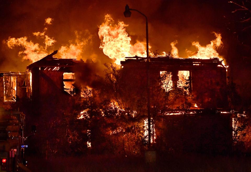 Flames rise above the remains of St. Ann Hospital Thursday Oct. 6, 2022. This was the second time the 82-year-old building had burned since a 2017 blaze was fought here.