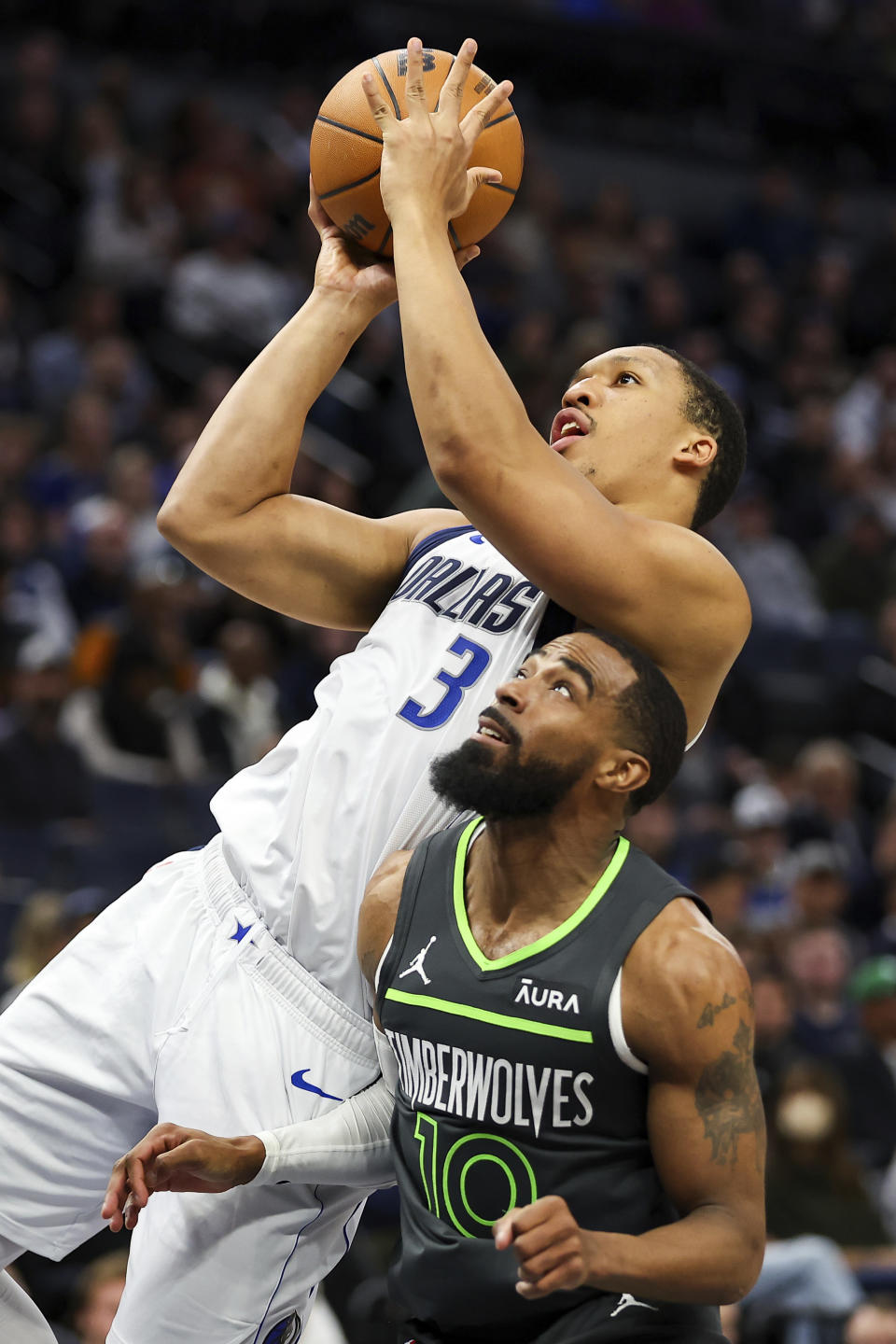 Dallas Mavericks forward Grant Williams (3) shoots as Minnesota Timberwolves guard Mike Conley (10) defends during the first half of an NBA basketball game, Thursday, Dec. 28, 2023, in Minneapolis. (AP Photo/Matt Krohn)