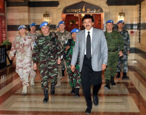 Moroccan advance team leader Colonel Ahmed Himmiche (second left) and Niraj Singh (centre), spokesman to the UN monitors team tasked with monitoring the UN-backed ceasefire in Syria, leave their hotel in Damascus on April 25 to visit flashpoint areas. A handful of UN observers resumed their tour as envoy Kofi Annan urged the fast deployment of the full, 300-strong mission