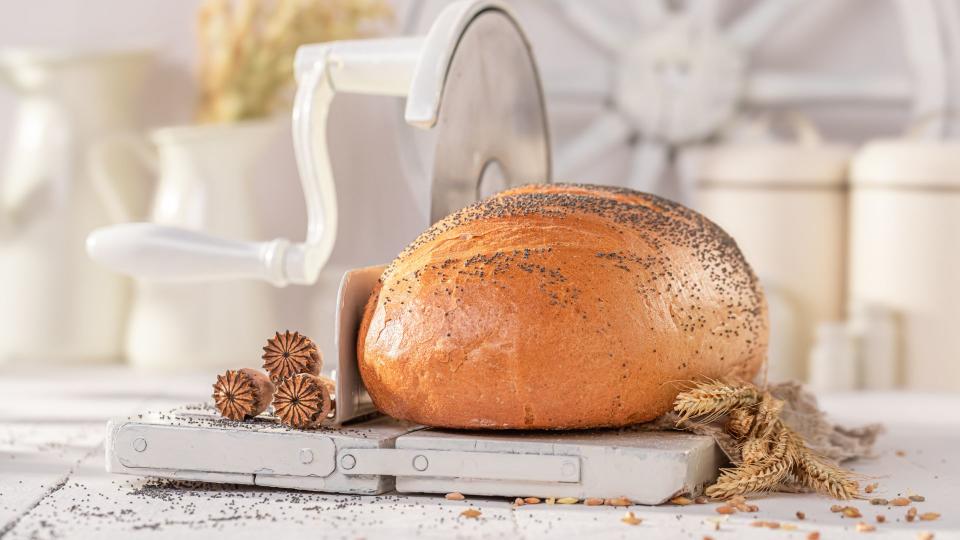 A loaf of bread on a slicer