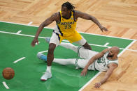 Indiana Pacers forward Aaron Nesmith (23) and Boston Celtics guard Derrick White (9) scramble for a loose ball during the fourth quarter of Game 1 of the NBA Eastern Conference basketball finals, Tuesday, May 21, 2024, in Boston. (AP Photo/Michael Dwyer)