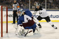 Colorado Avalanche goaltender Philipp Grubauer, front, stops a shot by Los Angeles Kings right wing Tyler Toffoli during the first period of an NHL hockey game Saturday, Feb. 15, 2020, at Air Force Academy, Colo. (AP Photo/David Zalubowski)