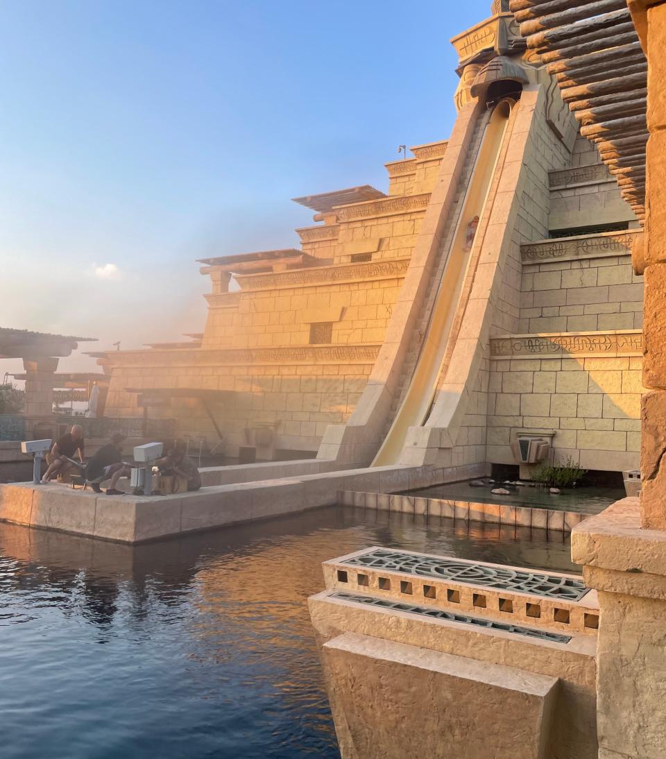 Someone plunges down a water slide in a temple