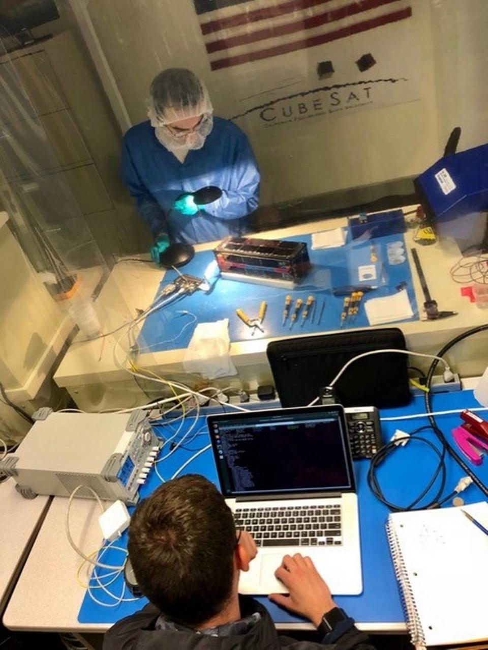 Mechanical engineering graduate student Aaron Fielden works with an unidentified student outside the Cal Poly clean room during testing of the ExoCube 2 satellite, a collaboration between the university and NASA’s Goddard Space Flight Center. Fielden was a project manager in 2016-17 for the ExoCube 2 satellite.