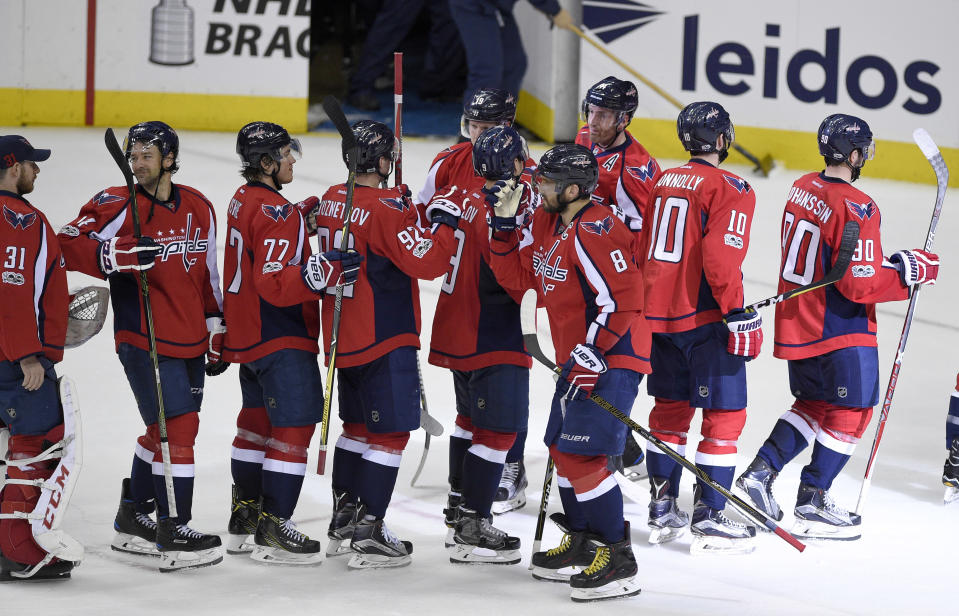 Washington Capitals left wing Alex Ovechkin (8), of Russia, and teammates celebrate a 2-0 win over the New York Rangers in an NHL hockey game, Wednesday, April 5, 2017, in Washington. (AP Photo/Nick Wass)