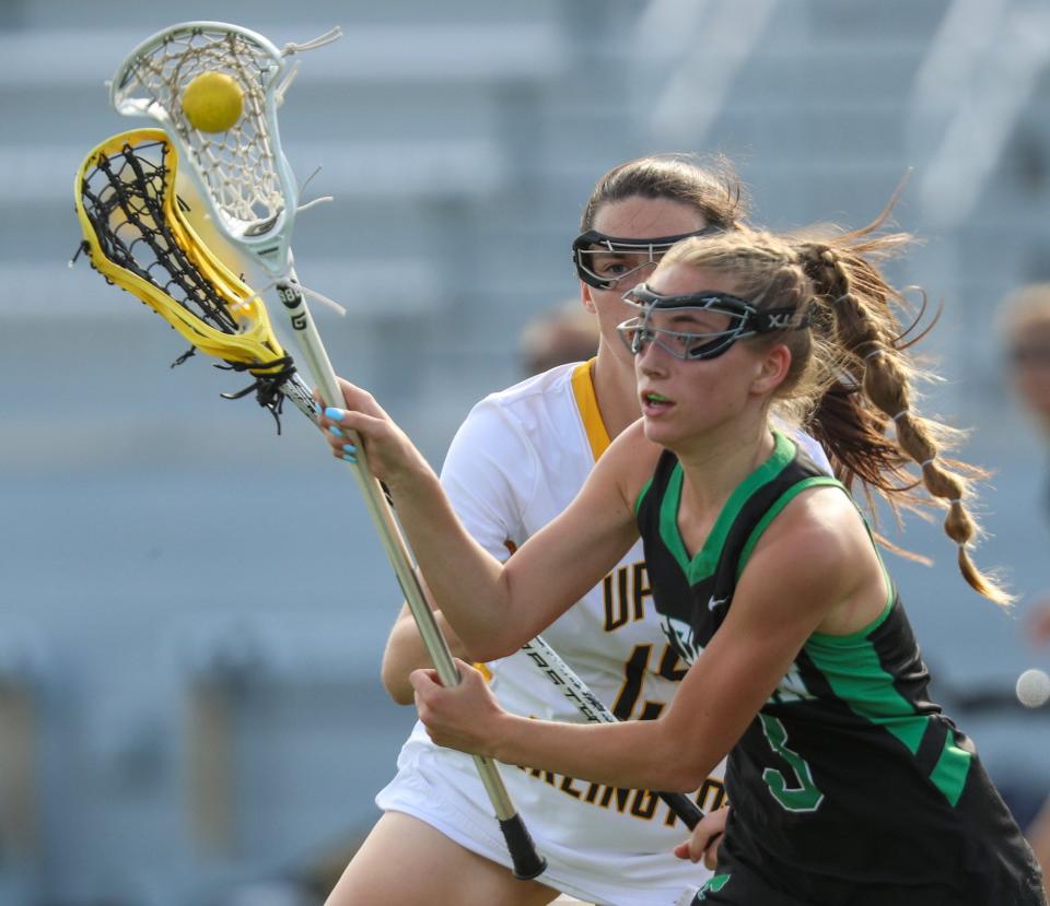 Upper Arlington's Vivian Lawless chases Dublin Coffman's Izzy King during the Division I, Region 1 final May 25. The Golden Bears beat the visiting Shamrocks 17-7.