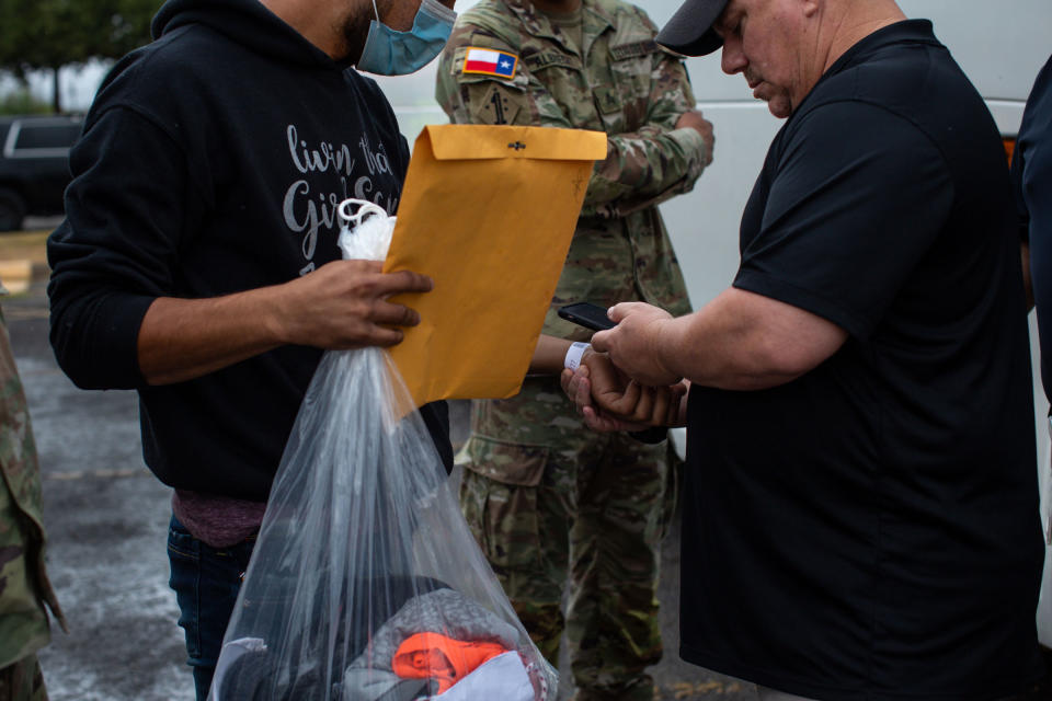 An official scans a migrant’s assigned barcoded wristband required to travel on an Operation Lone Star bus to either Washington, D.C. or New York, New York, from the Val Verde Border Humanitarian Coalition in Del Rio, Texas, on Aug. 15, 2022.<span class="copyright">Kaylee Greenlee Beal for TIME</span>