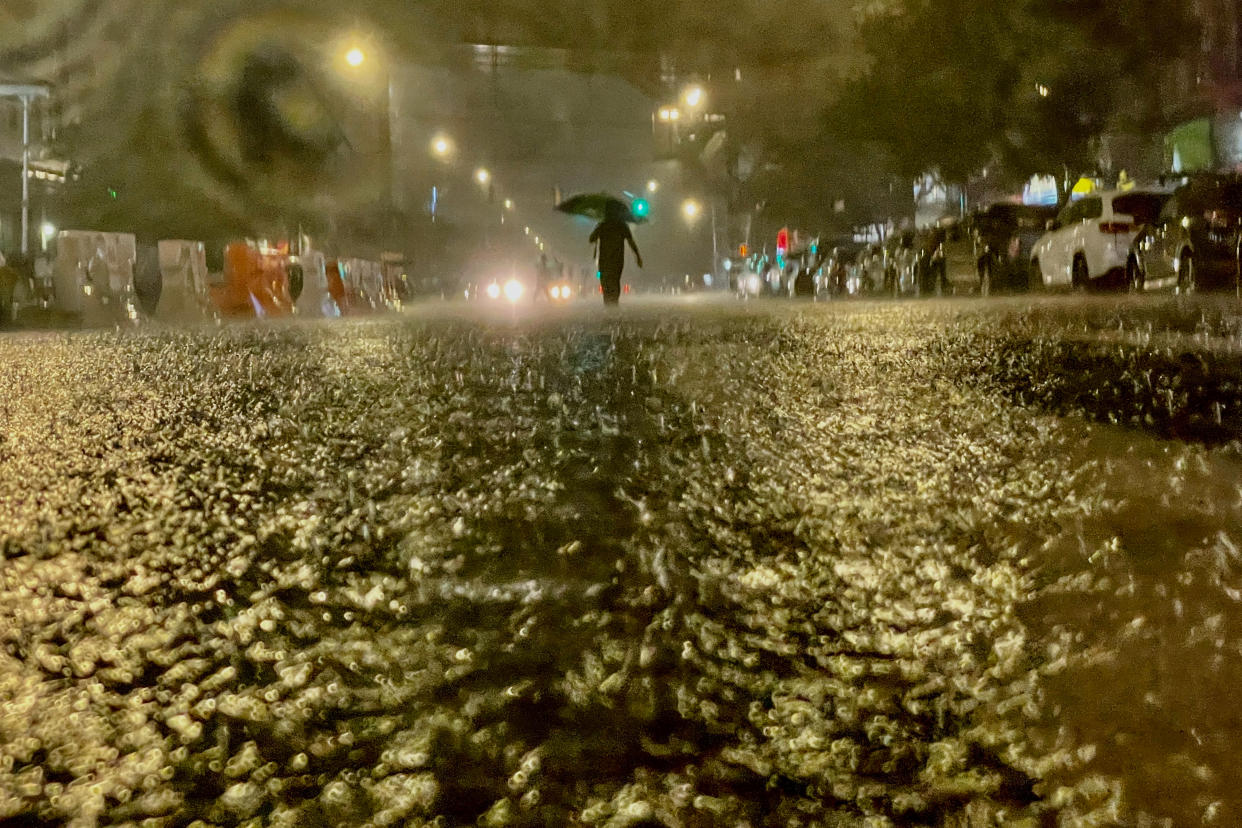 A person on foot braves the rain Wednesday in the Bronx borough of New York City. 