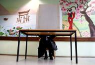 A woman casts her vote during regional elections at a polling station in Bad Kreuznach, in the German federal state of Rhineland-Palatinate, March 13, 2016. REUTERS/Kai Pfaffenbach