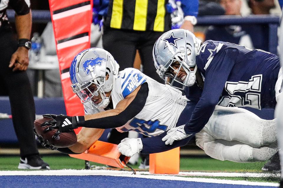 Amon-Ra St. Brown scores a TD against Cowboys cornerback Stephon Gilmore during the Lions' 20-19 loss last season.