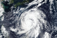 This Oct. 9, 2019, satellite photo taken by NASA-NOAA's Suomi NPP satellite shows typhoon Hagibis approaching Japan, top. Japan’s weather agency is warning a powerful typhoon may bring torrential rains to central Japan over the weekend. Typhoon Hagibis had winds gusting up to 270 kilometers per hour (168 mph) Thursday morning. It is expected to weaken over cooler waters as it nears Japan’s main island.(NASA Worldview, Earth Observing System Data and Information System (EOSDIS) via AP)