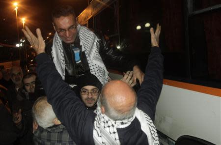 Newly released Palestinian prisoner Ibraheem Taktook (top) is greeted by relatives and friends upon his arrival at his home in the West Bank city of Nablus early December 31, 2013. Israel freed 26 Palestinian prisoners, including Taktook, on Tuesday, days before U.S. Secretary of State John Kerry was due back in the Middle East to press the two sides to agree a framework peace deal. REUTERS/Abed Omar Qusini