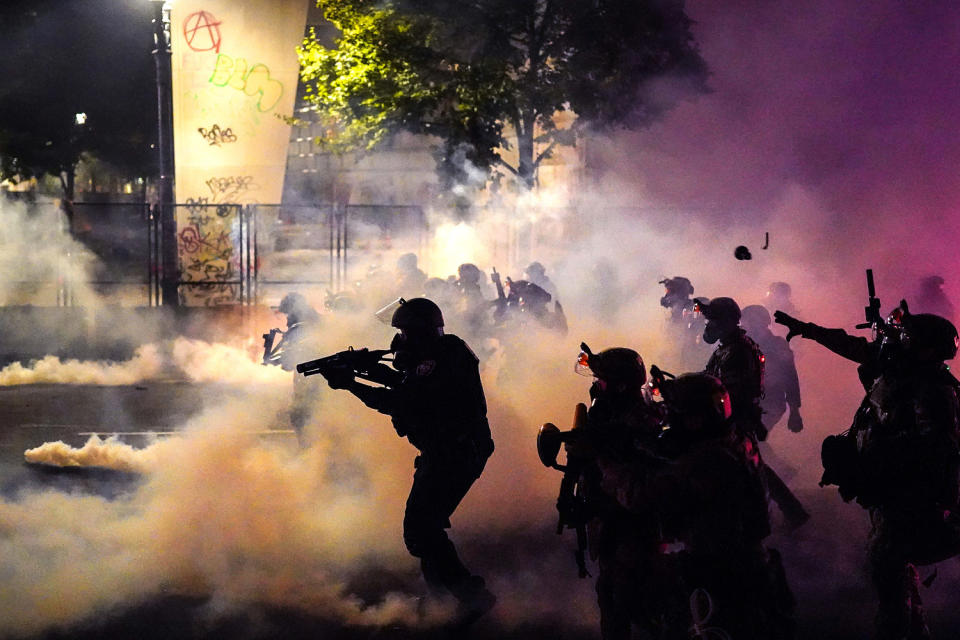 Federal officers deploy tear gas and less-lethal munitions while dispersing a crowd of about a thousand protesters in front of the Mark O. Hatfield U.S. Courthouse (Nathan Howard / Getty Images file)