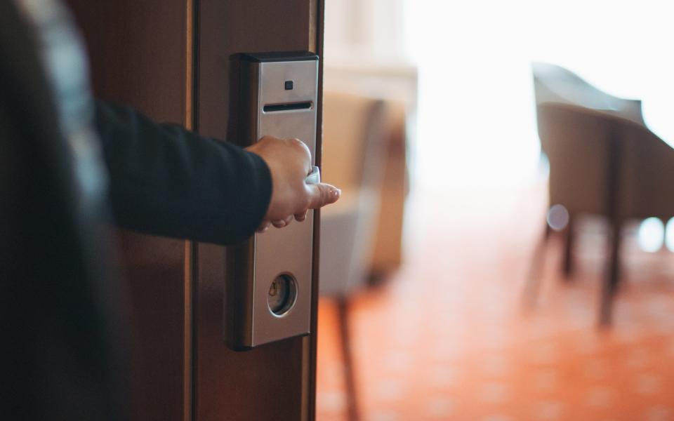 Someone opening a hotel room door