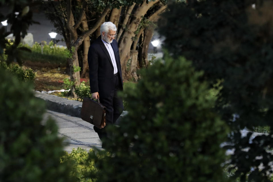 In this picture made available by Iranian state-run TV, IRIB, candidate for the presidential election Saeed Jalili, a hard-line former Iranian top nuclear negotiator, arrives for his debate with the reformist candidate Masoud Pezeshkian at the TV studio in Tehran, Iran, Monday, July 1, 2024. (Morteza Fakhri Nezhad/IRIB via AP)