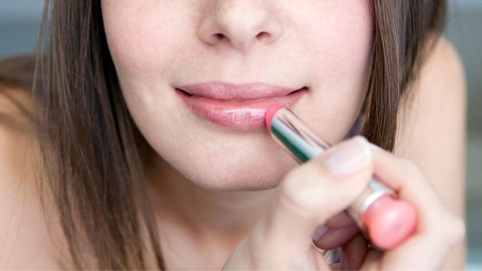 woman applying lipstick