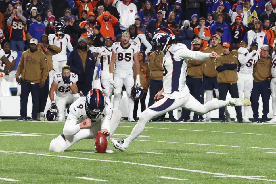 Denver Broncos place kicker Wil Lutz, right, kicks the winning field goal during the second half of an NFL football game against the Buffalo Bills, Monday, Nov. 13, 2023, in Orchard Park, N.Y. (AP Photo/Jeffrey T. Barnes)