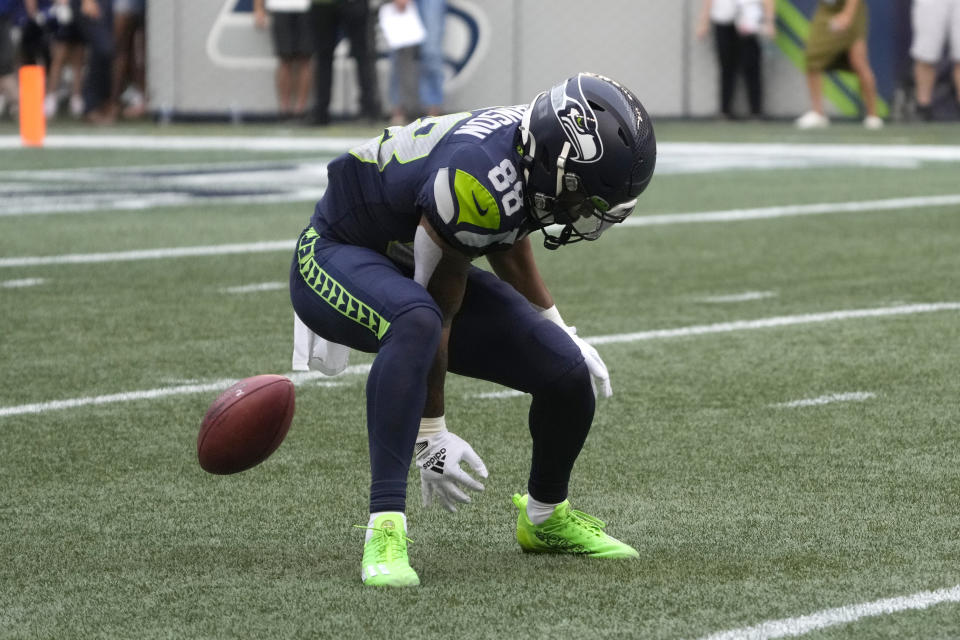 Seattle Seahawks' Cade Johnson fumbles on a punt return against the Chicago Bears during the first half of a preseason NFL football game, Thursday, Aug. 18, 2022, in Seattle. The ball was recovered by the Bears' Elijah Hicks for a touchdown. (AP Photo/Stephen Brashear)