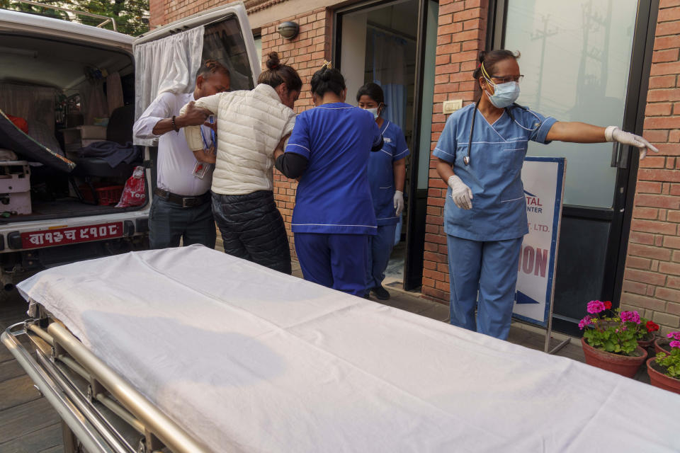 An injured Indian climber who was rescued from the Annapurna mountain region is brought to a hospital in Kathmandu, Nepal, Tuesday, April 18, 2023. An Irish climber died and an Indian is missing after falling into a crevasse in two separate incidents on Mount Annapurna, the world's 10th highest mountain, an expedition organizer said Tuesday. (AP Photo/Niranjan Shrestha)