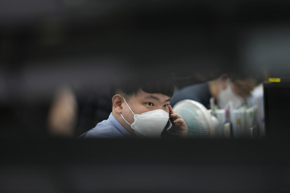 A currency trader talks on the phone at a foreign exchange dealing room in Seoul, South Korea, Wednesday, March 22, 2023. Asian shares advanced Wednesday after a Wall Street rally led by the banks most beaten down by the industry’s crisis.(AP Photo/Lee Jin-man)