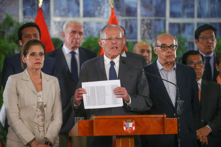 Peruvian President Pedro Pablo Kuczynski (C), flanked by vice-president Mercedes Araoz (L) and his cabinet, gives a speech at the Government Palace in Lima, Peru, December 14, 2017. Peruvian Government Palace/Handout via Reuters.