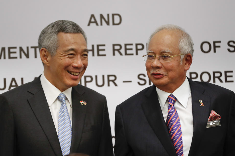 Singapore's Prime Minister Lee Hsien Loong, left, chats with Malaysia's Prime Minister Najib Razak during a signing ceremony of agreement on the Kuala Lumpur-Singapore High Speed Rail (HSR) project in Putrajaya, Malaysia, Tuesday, Dec. 13, 2016. Malaysia and Singapore today signed the long-awaited agreement on the Kuala Lumpur-Singapore High Speed Rail (HSR) project. (AP Photo/Vincent Thian)