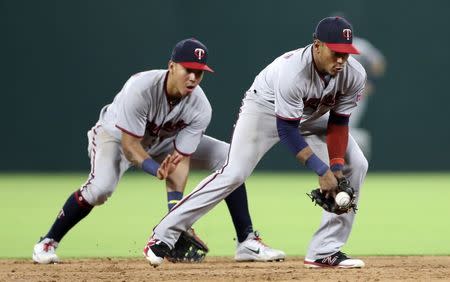 Aug 31, 2018; Arlington, TX, USA; Minnesota Twins shortstop Jorge Polanco (11) commits a fielding error in front of second baseman Ehire Adrianza (16) during the sixth inning against the Texas Rangers at Globe Life Park in Arlington. Mandatory Credit: Kevin Jairaj-USA TODAY Sports