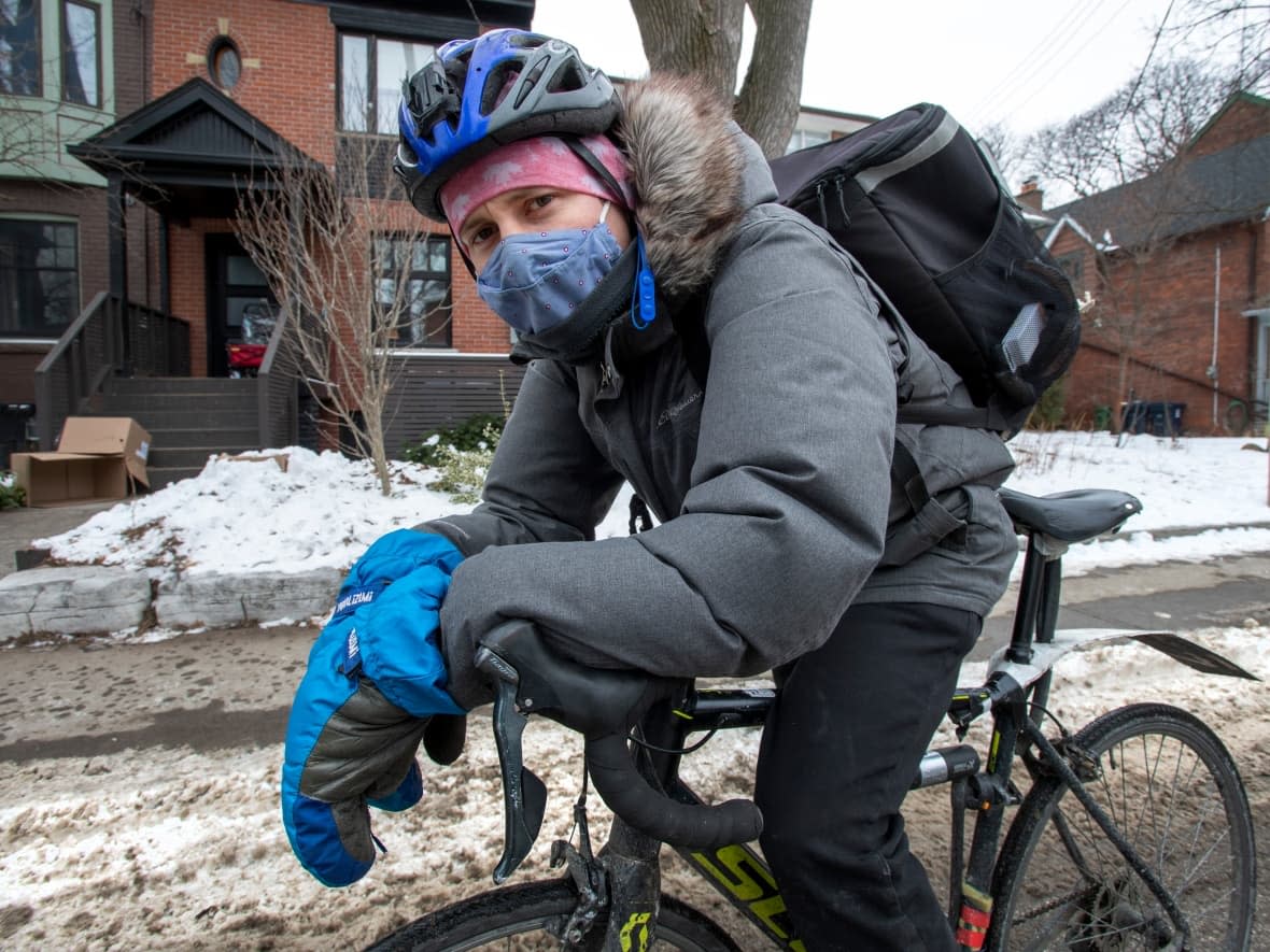 Uber Eats courier Spencer Thompson is shown in Toronto in a 2021 file photo. On the heels of new recommendations being made for gig workers by the Ontario provincial government, an Alberta labour leader says a conversation needs to be had around the future of gig work in the province. (Frank Gunn/The Canadian Press - image credit)